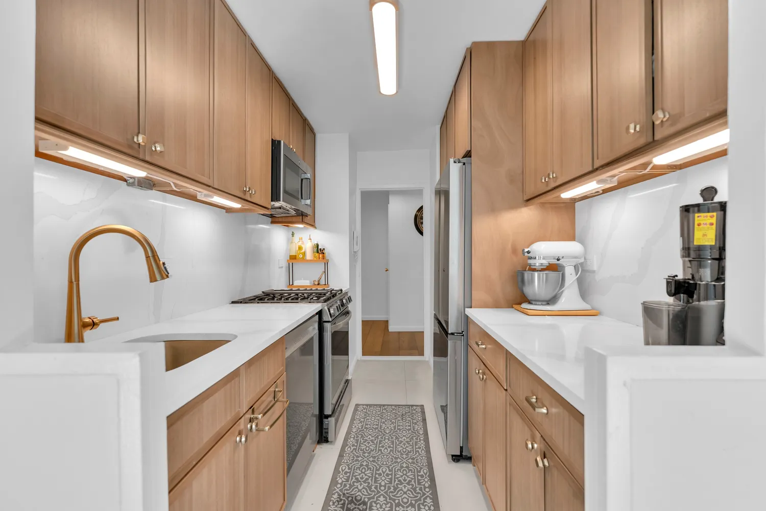 a kitchen with sink a refrigerator and cabinets
