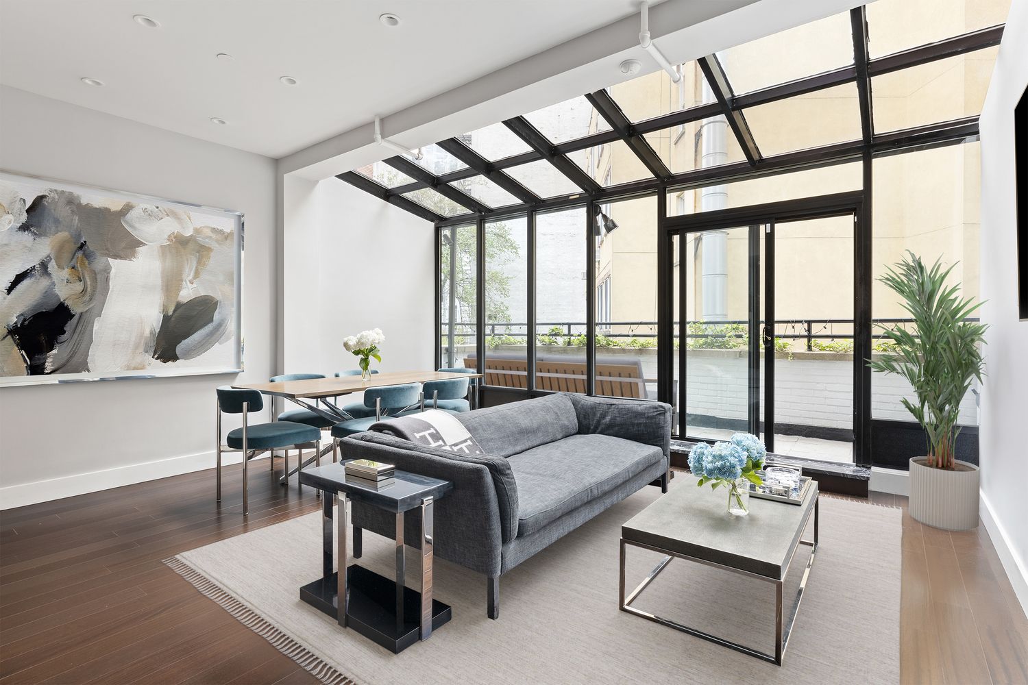 a living room with furniture and large windows