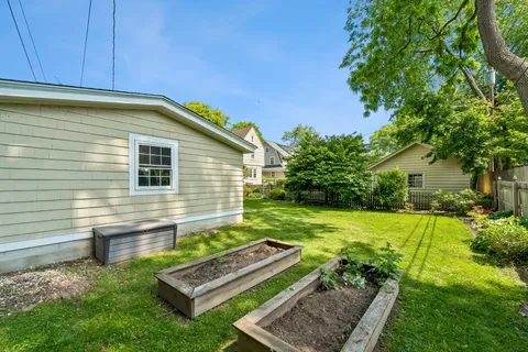 a view of a backyard with plants and a patio