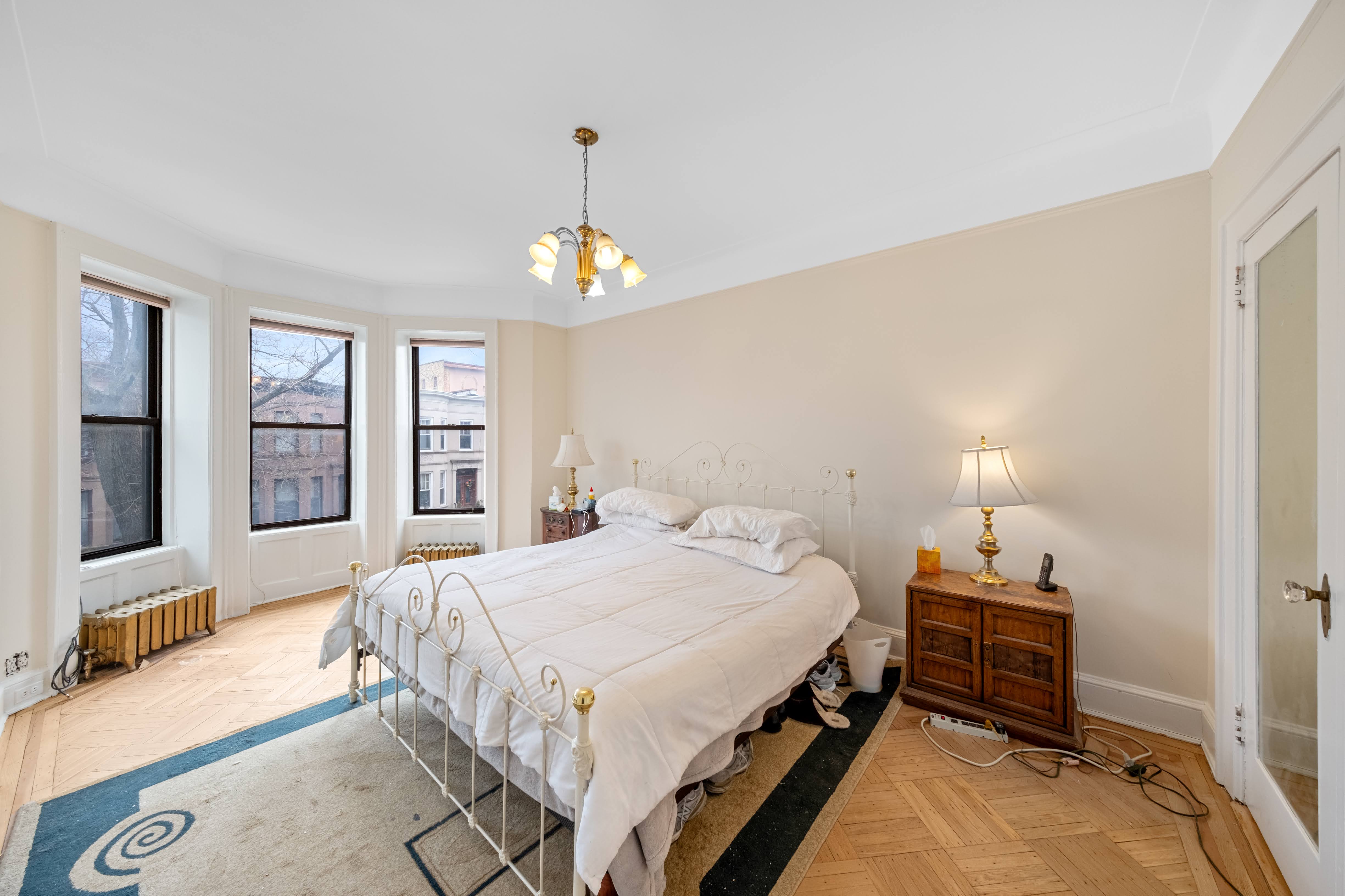 196 Maple Street Brooklyn, NY 11225 - Photo 10 of 31 a bedroom with a bed and window