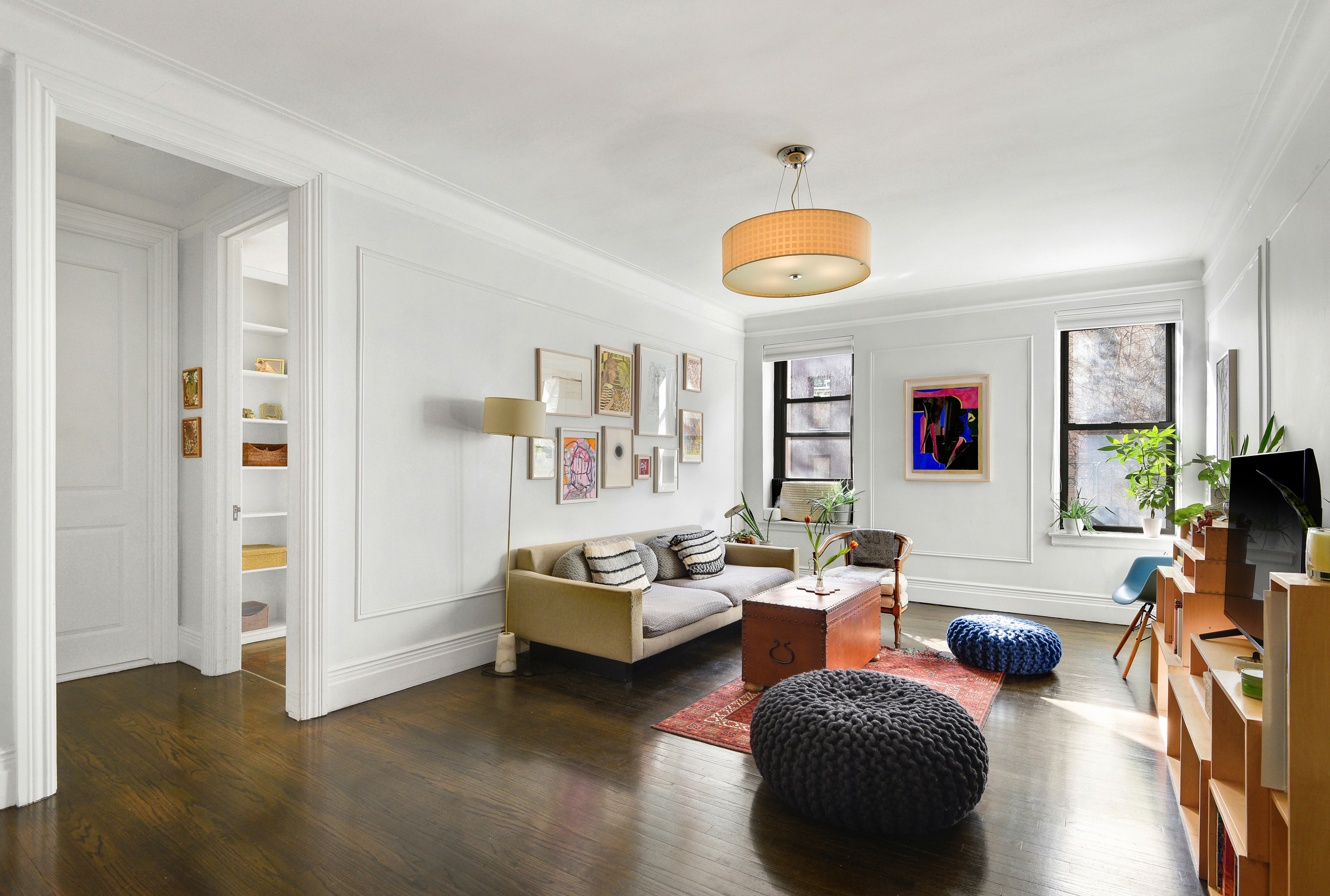 253 West 16th Street, Unit 3A Manhattan, NY 10011 - Photo 2 of 13 a living room with furniture and a large window