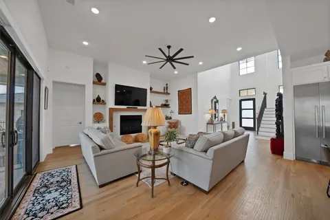 a living room with furniture a fireplace and a flat screen tv