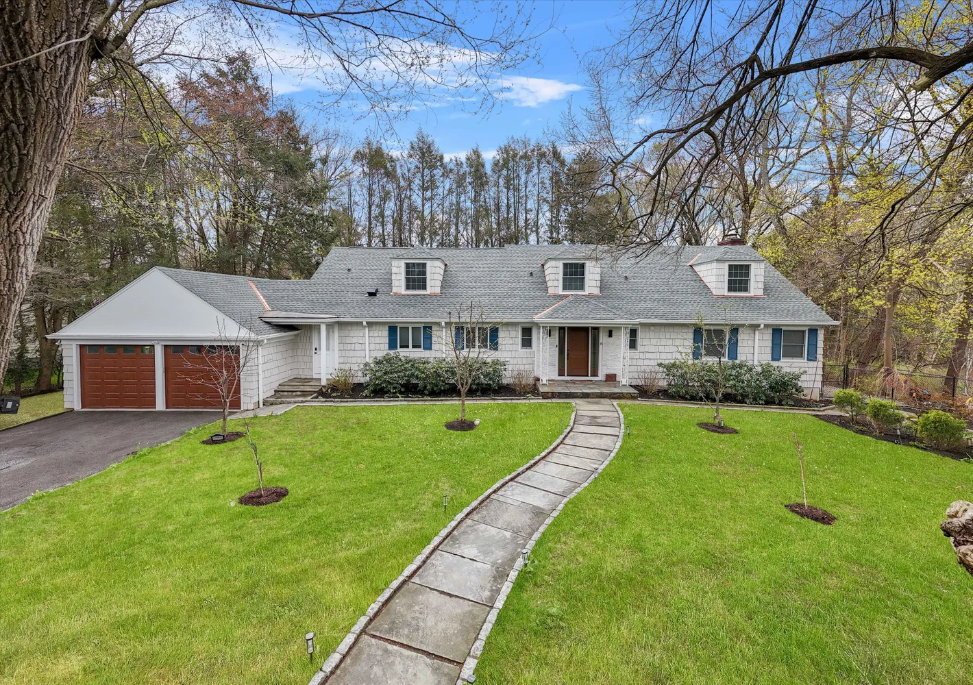 a front view of a house with a yard table and chairs