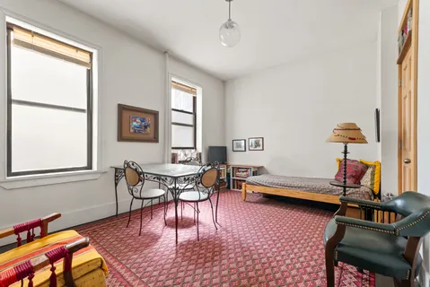 a bedroom with furniture and a window