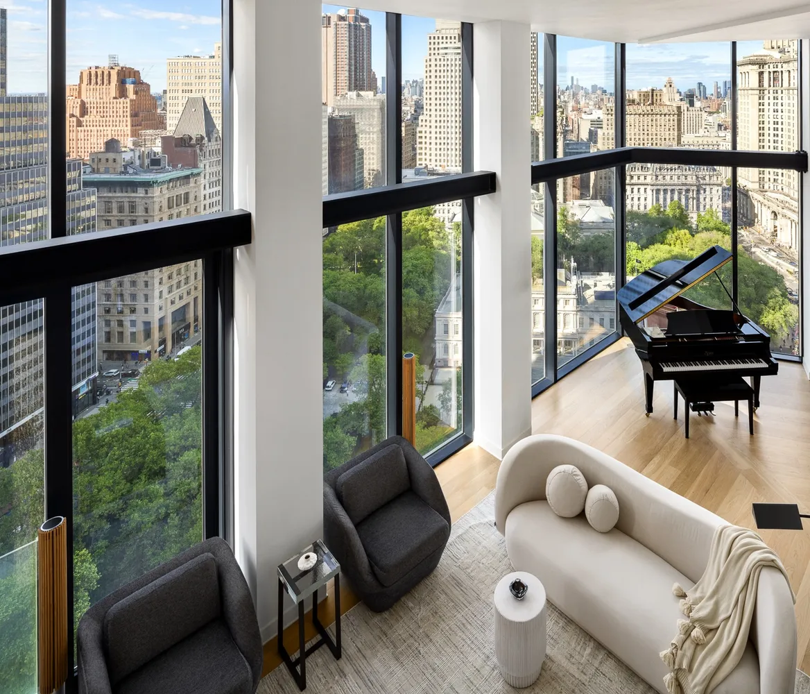 a living room with furniture and a floor to ceiling window