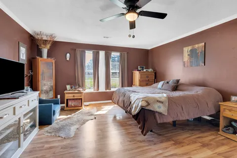 a bedroom with a bed and a flat screen tv