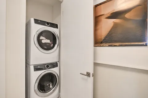 a view of a hallway with washer and dryer