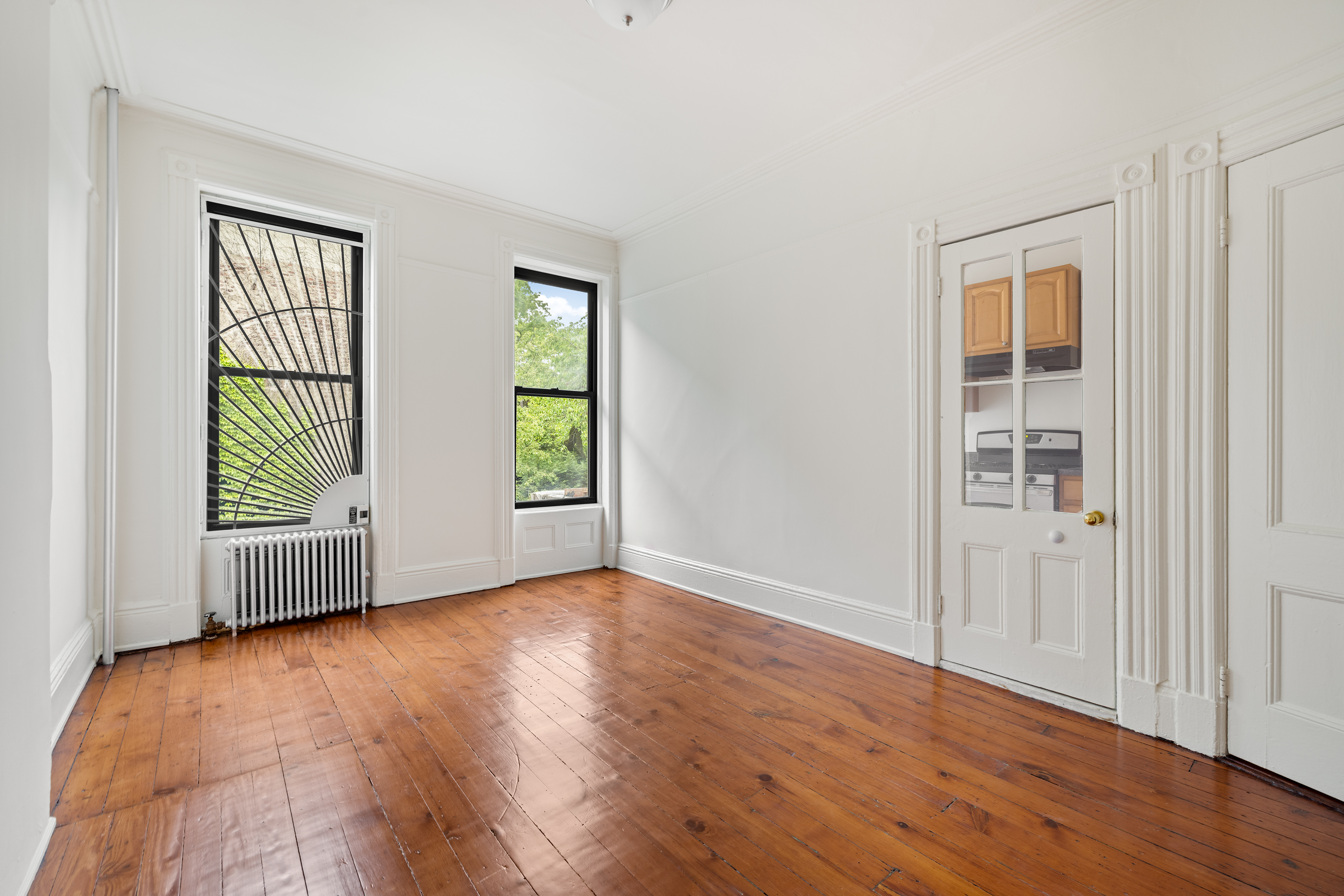 353 7th Avenue, Unit 1 Brooklyn, NY 11215 - Photo 2 of 8 an empty room with wooden floor and windows