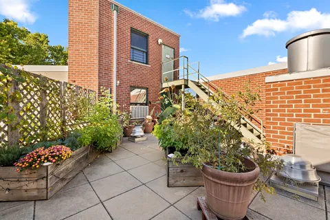 a view of a backyard with sitting area