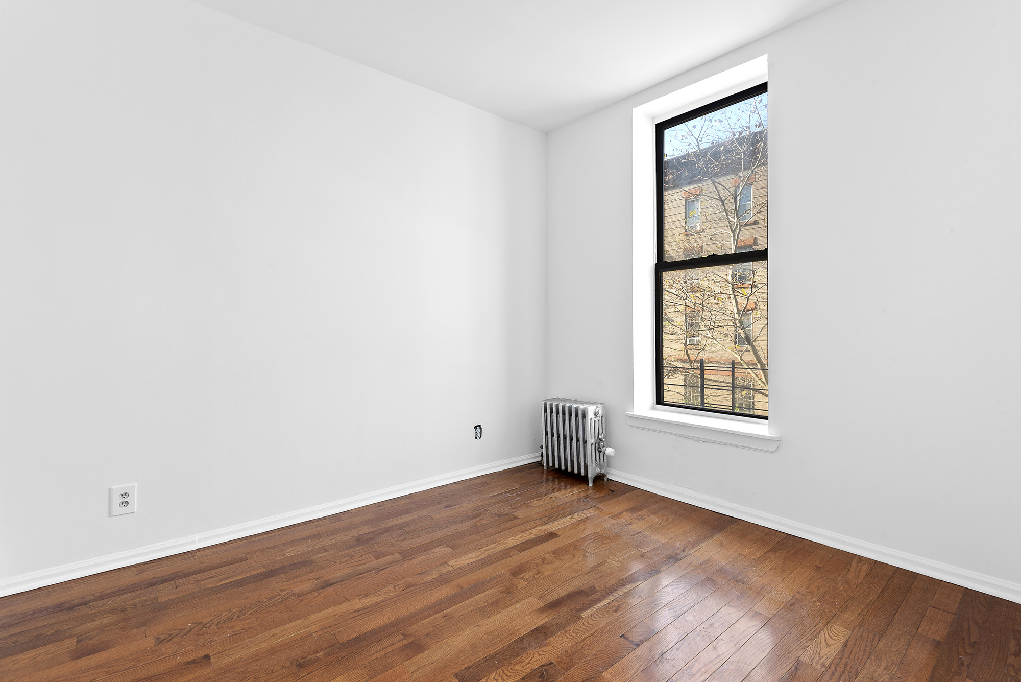 570 Jefferson Avenue, Unit 4 Brooklyn, NY 11221 - Photo 4 of 8 an empty room with wooden floor and windows