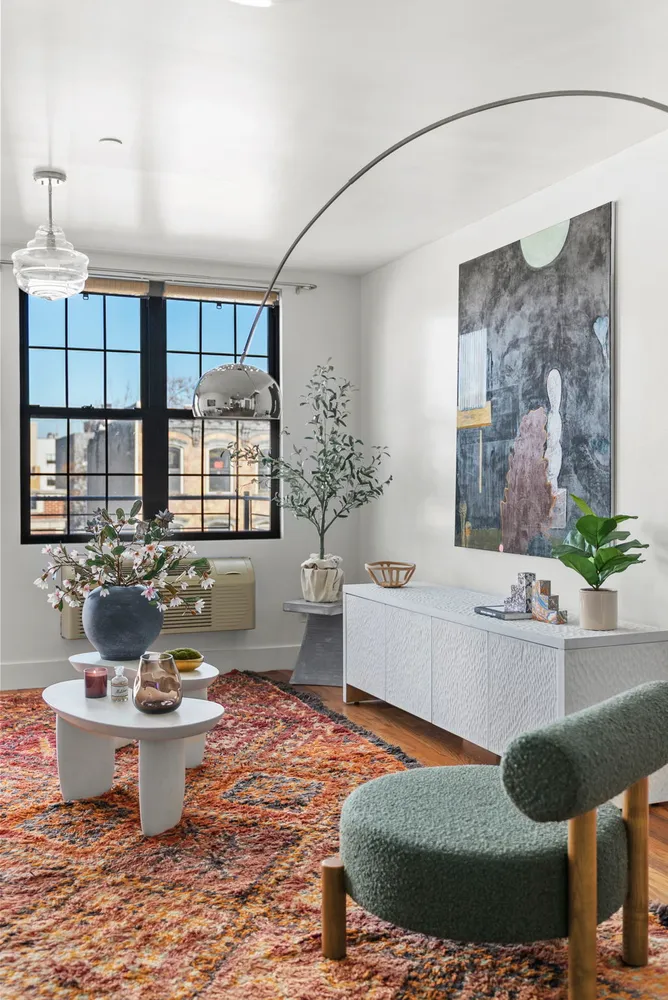 a living room with furniture and a potted plant