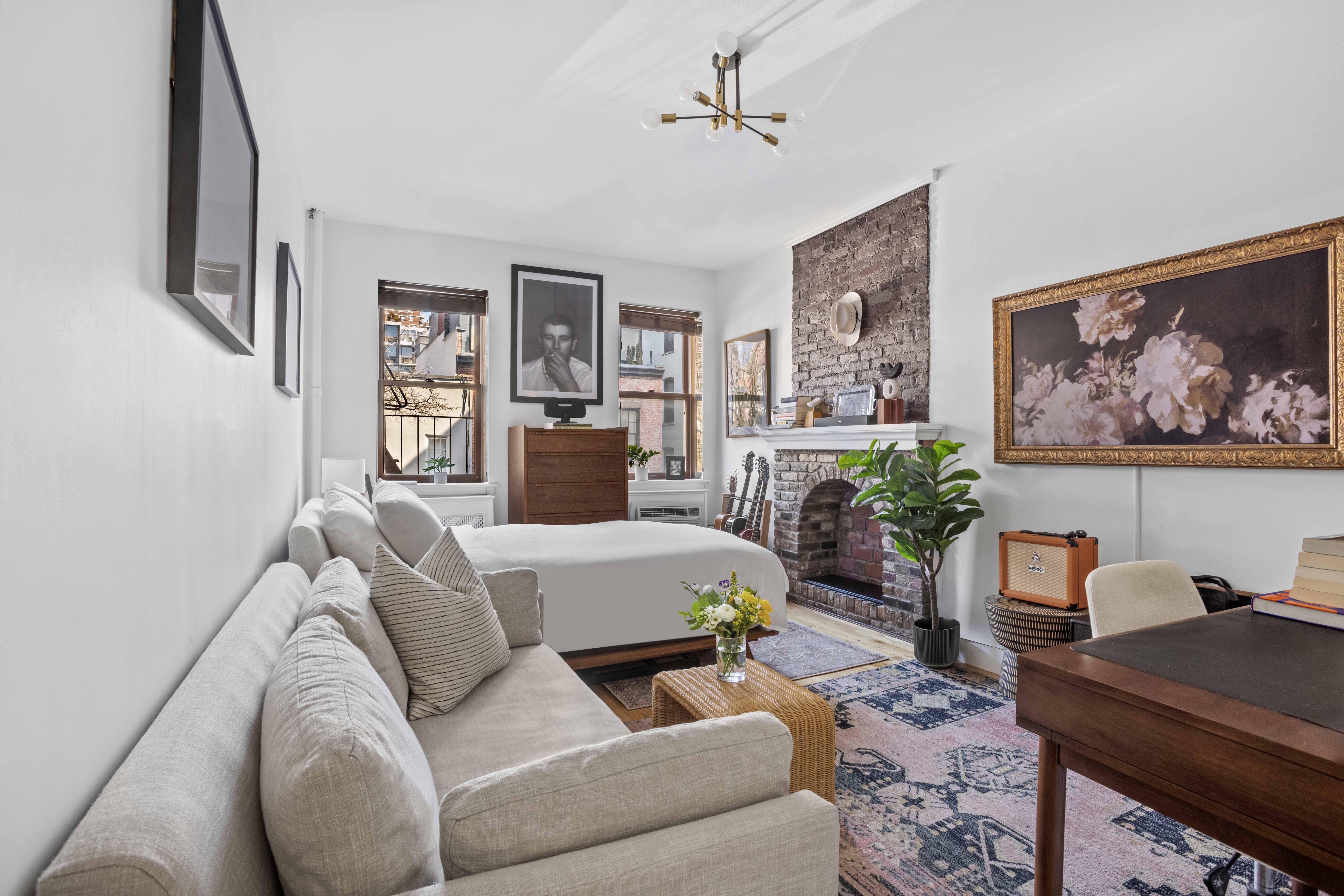 335 West 21st Street, Unit 3RE Manhattan, NY 10011 - Photo 2 of 7 a living room with furniture a table and a painting