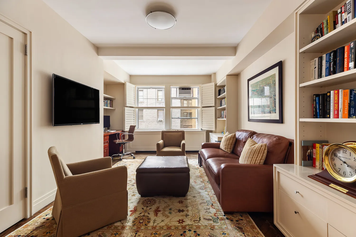 a living room with furniture workspace and a flat screen tv