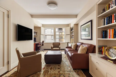 a living room with furniture workspace and a flat screen tv