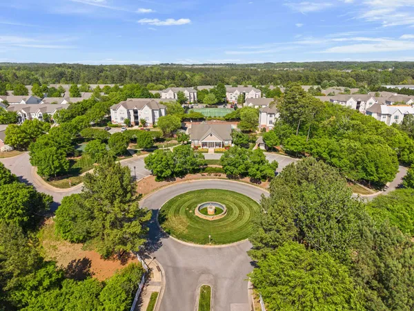 a view of a city with lush green forest