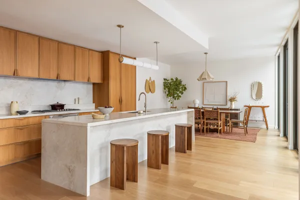 a kitchen with a table chairs sink and cabinets