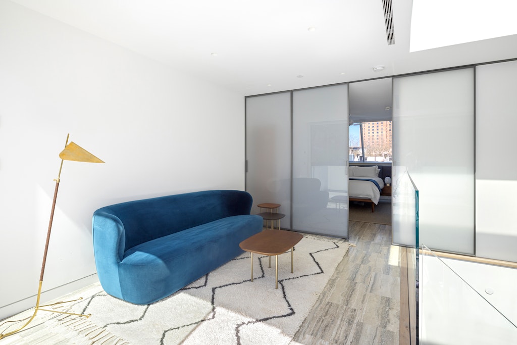 125 West 87th Street Manhattan, NY 10024 - Photo 19 of 27 a living room with a couch and a walk in closet with wooden floor
