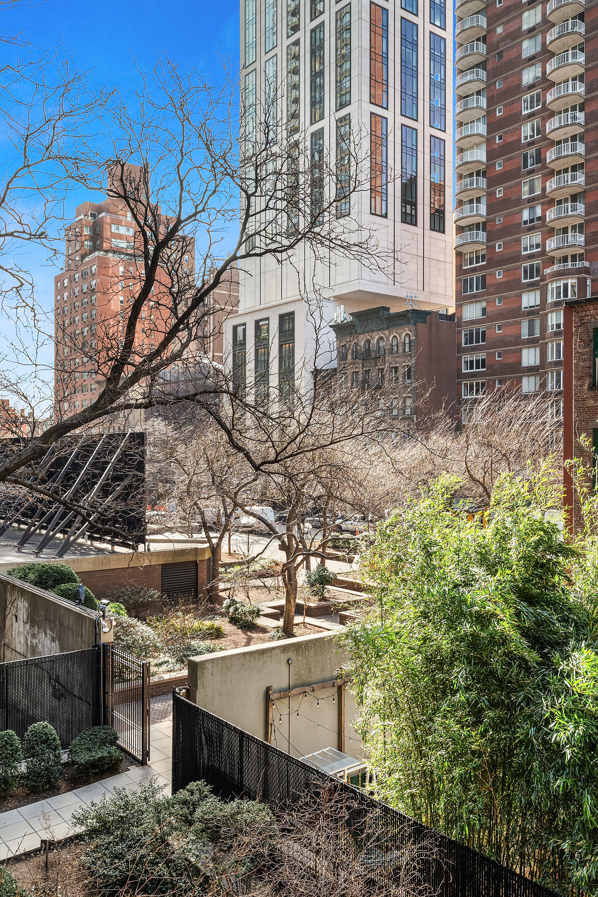400 East 59th Street, Unit 3G Manhattan, NY 10022 - Photo 6 of 7 a view of a building with a tree