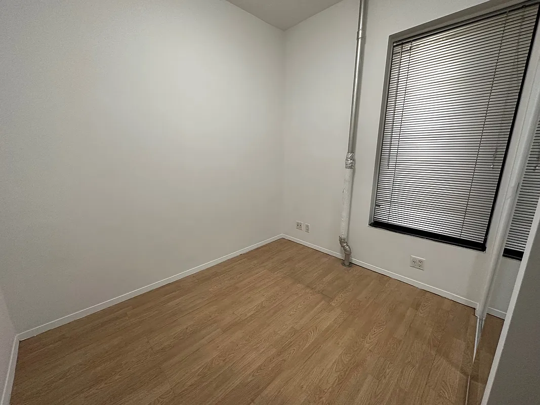 1315 3rd Avenue, Unit 4A Manhattan, NY 10021 - Photo 5 of 5 a view of an empty room with a window
