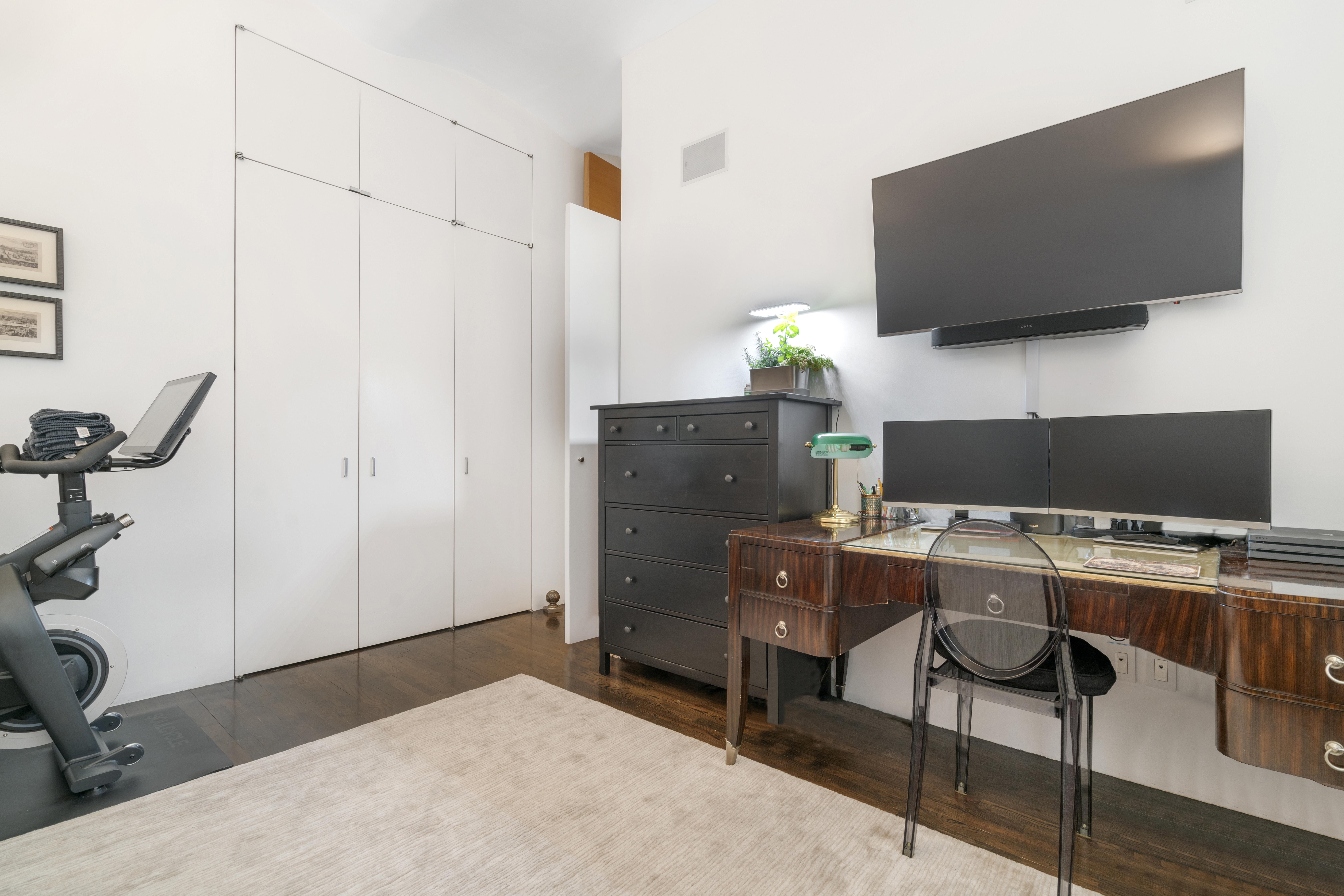 312 East 23rd Street, Unit 7B Manhattan, NY 10010 - Photo 8 of 14 a workspace with furniture and wooden floor