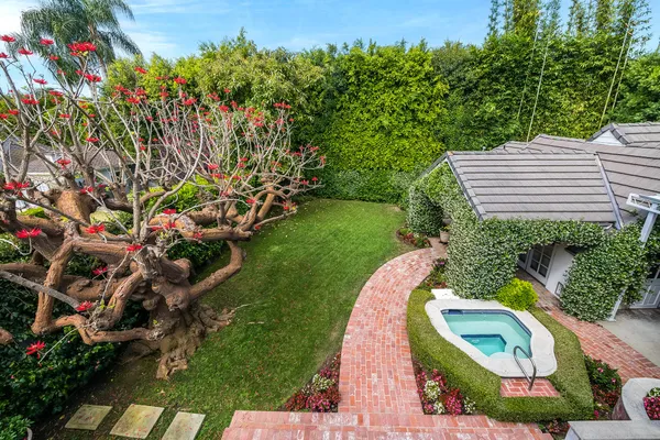 a view of a house with a backyard and garden