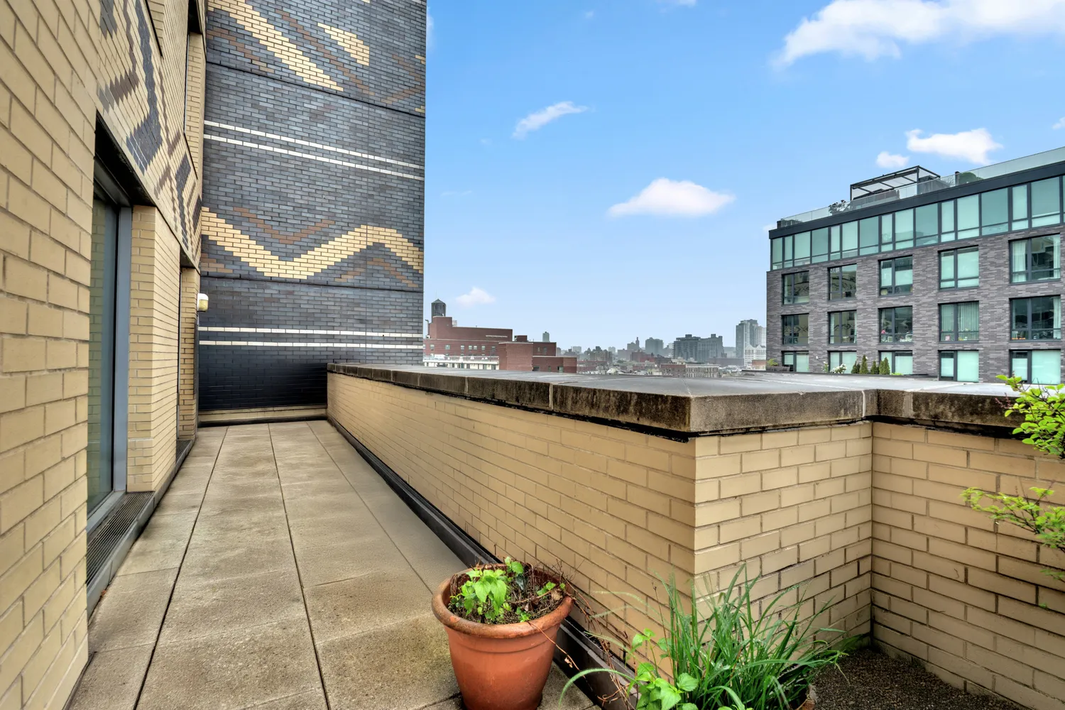 a view of a patio with table and chairs and potted plants