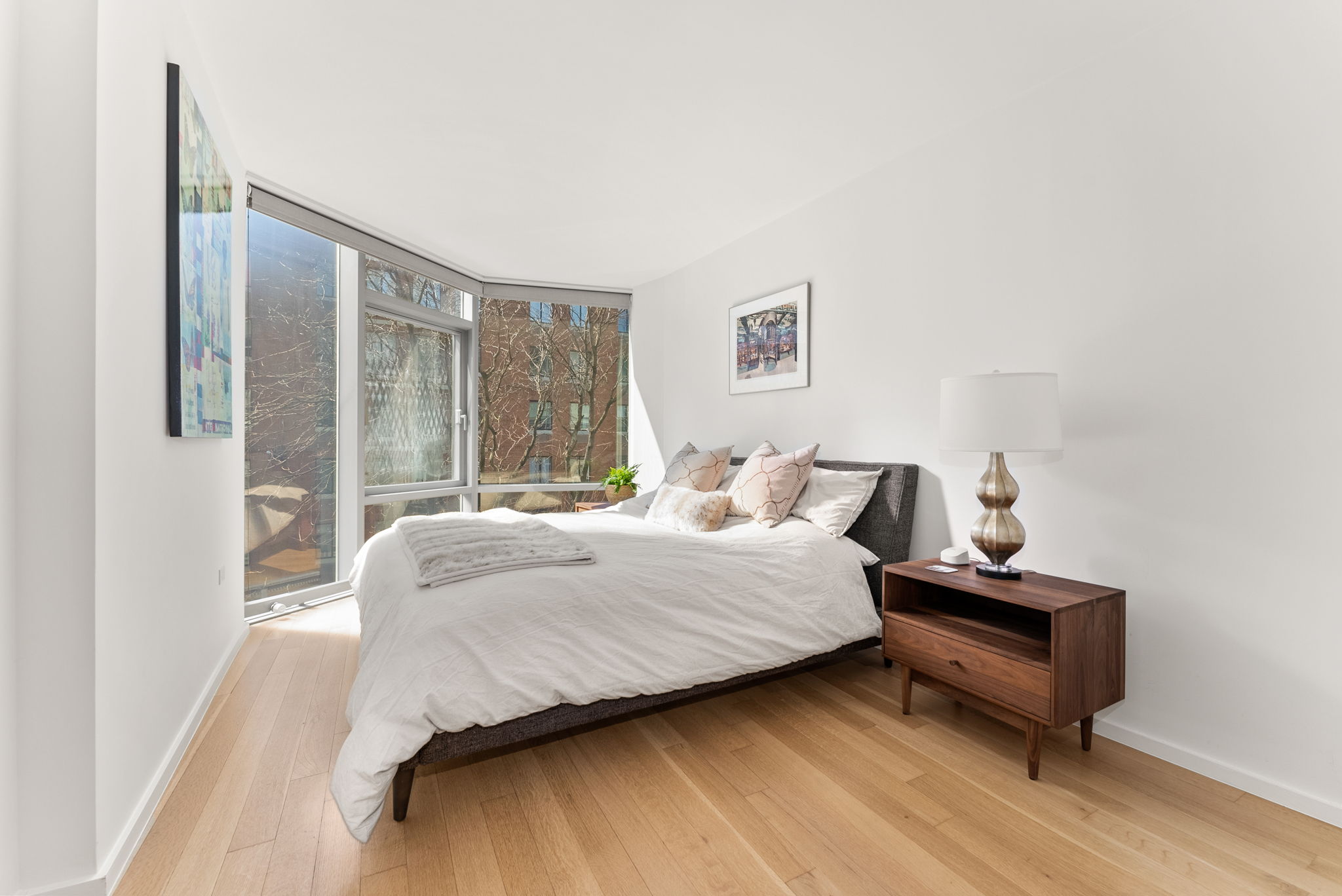 425 West 53rd Street, Unit 416 Manhattan, NY 10019 - Photo 10 of 19 a bedroom with a bed and a window