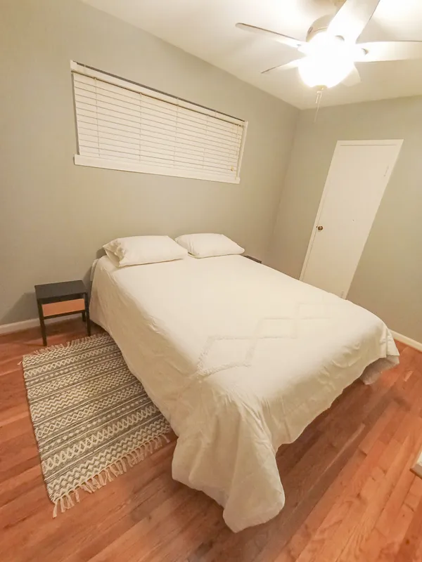 a large white bed in a small room