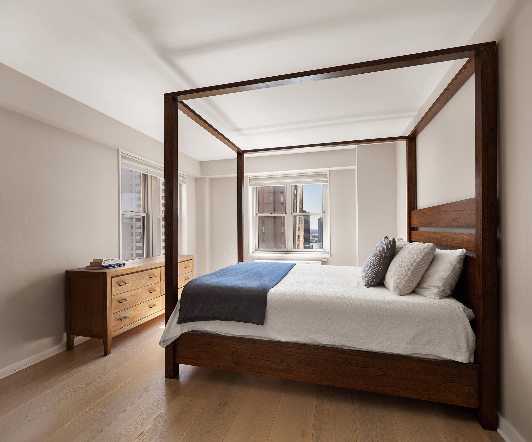 137 East 36th Street, Unit 24C Manhattan, NY 10016 - Photo 3 of 12 a bedroom with a bed window and a dresser in it