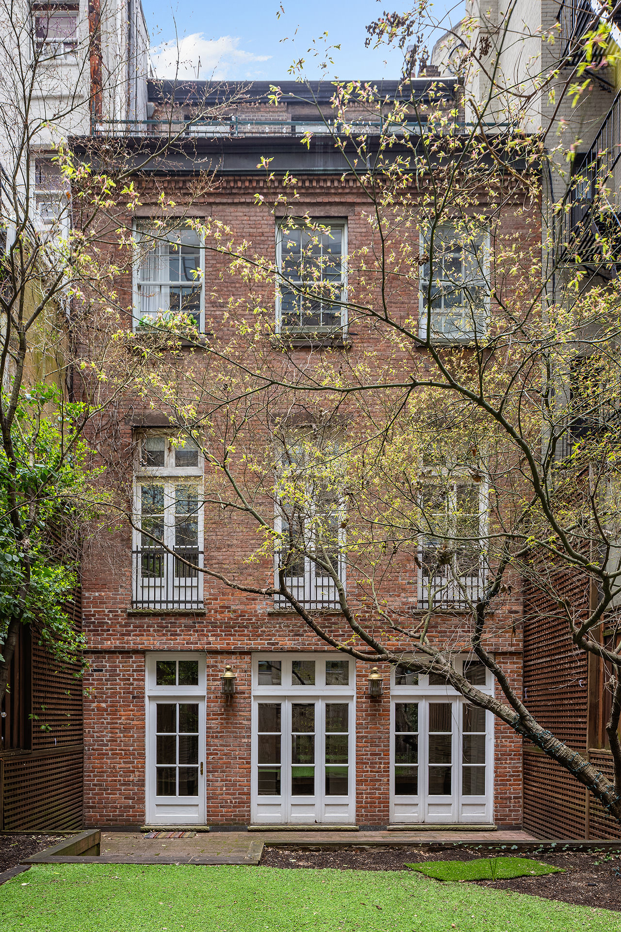23 West 12th Street, Unit 1 Manhattan, NY 10011 - Photo 3 of 13 a front view of a building with yard and green space