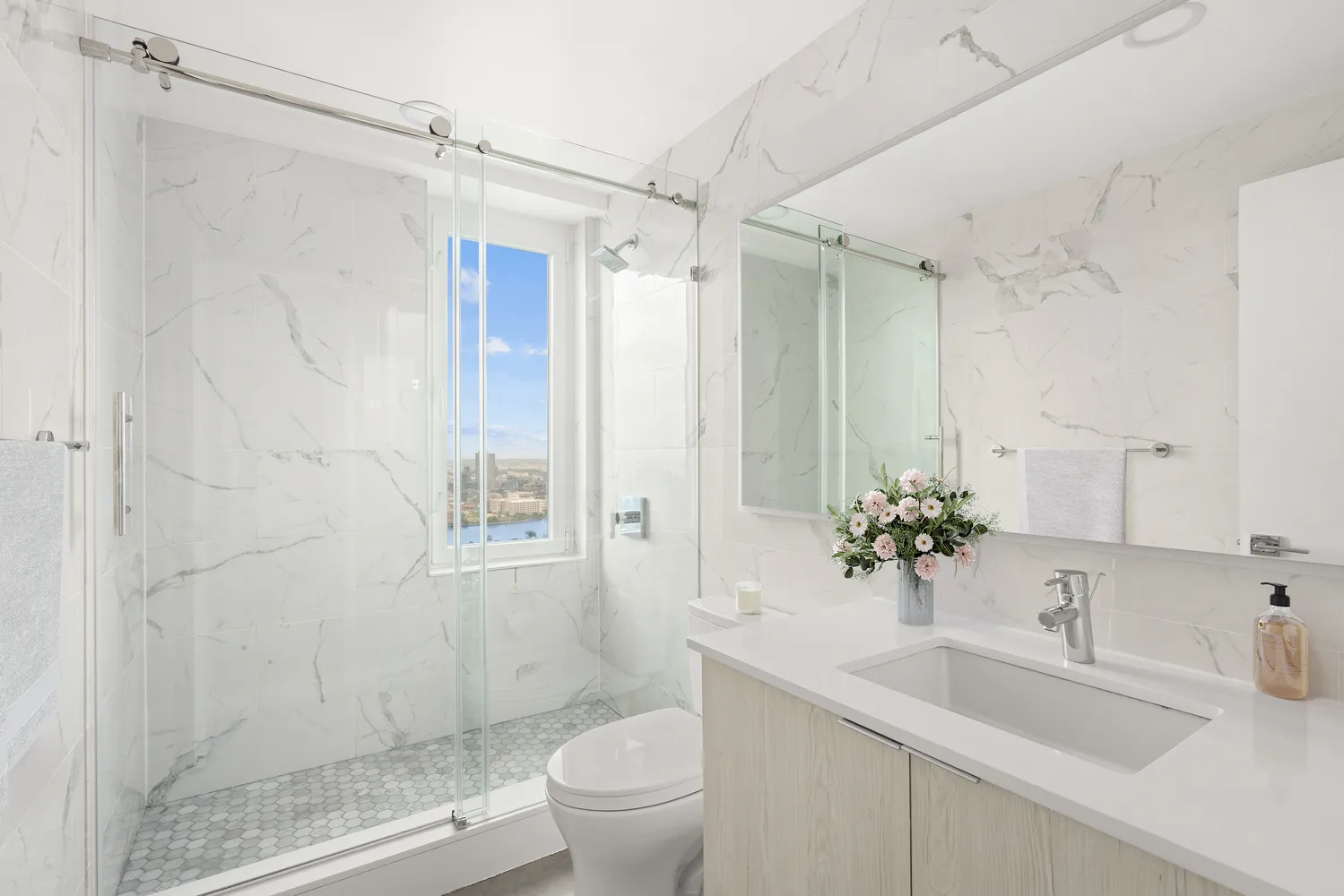 a bathroom with a sink toilet and shower