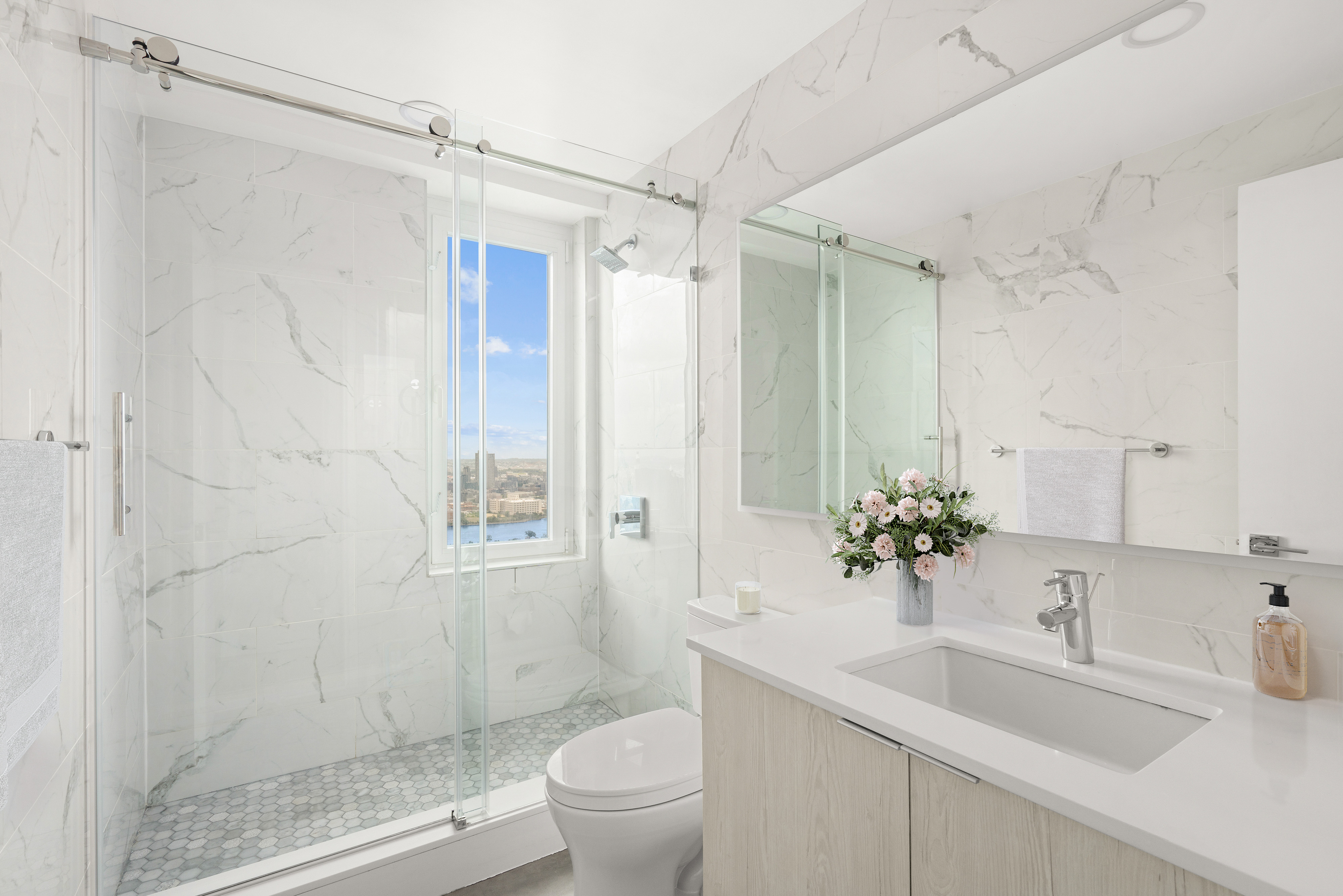 303 East 57th Street, Unit 41G Manhattan, NY 10022 - Photo 8 of 15 a bathroom with a sink toilet and shower