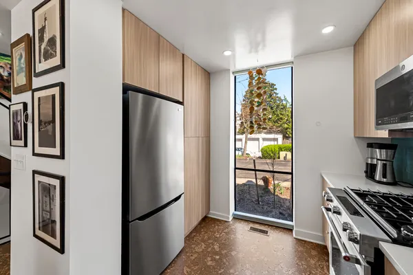 a kitchen with stainless steel appliances granite countertop a refrigerator and a stove top oven
