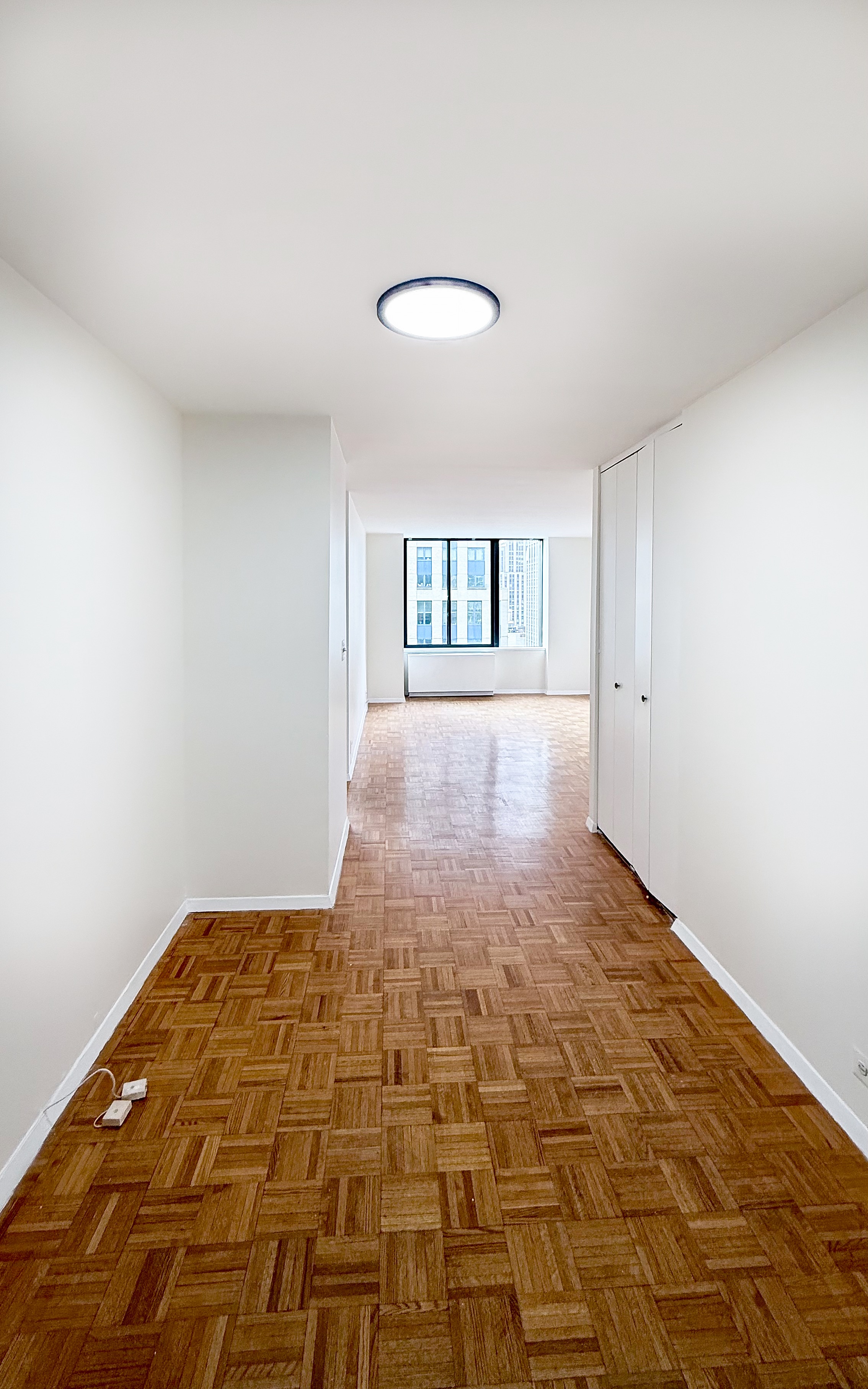 445 5th Avenue, Unit 23D Manhattan, NY 10016 - Photo 3 of 15 a view of empty room with windows