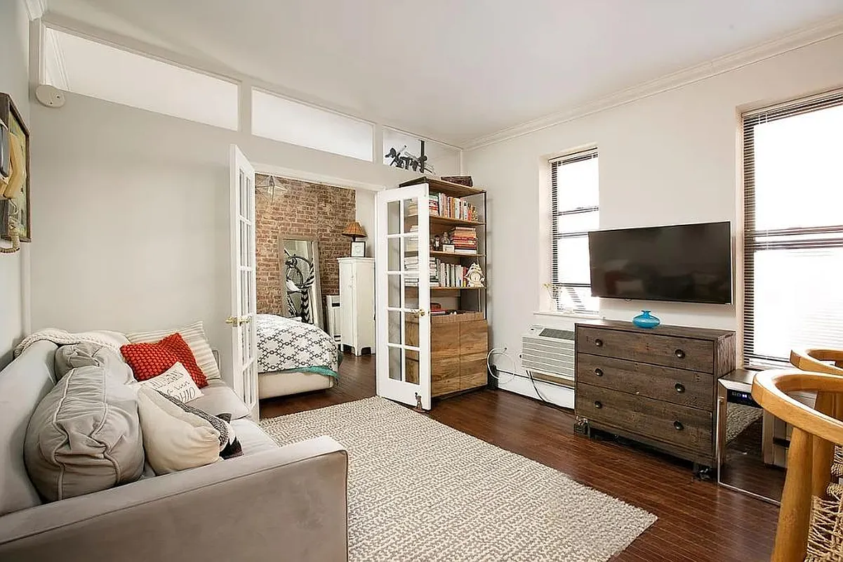 314 West 94th Street, Unit 5E Manhattan, NY 10025 - Photo 6 of 9 a living room with furniture and a flat screen tv