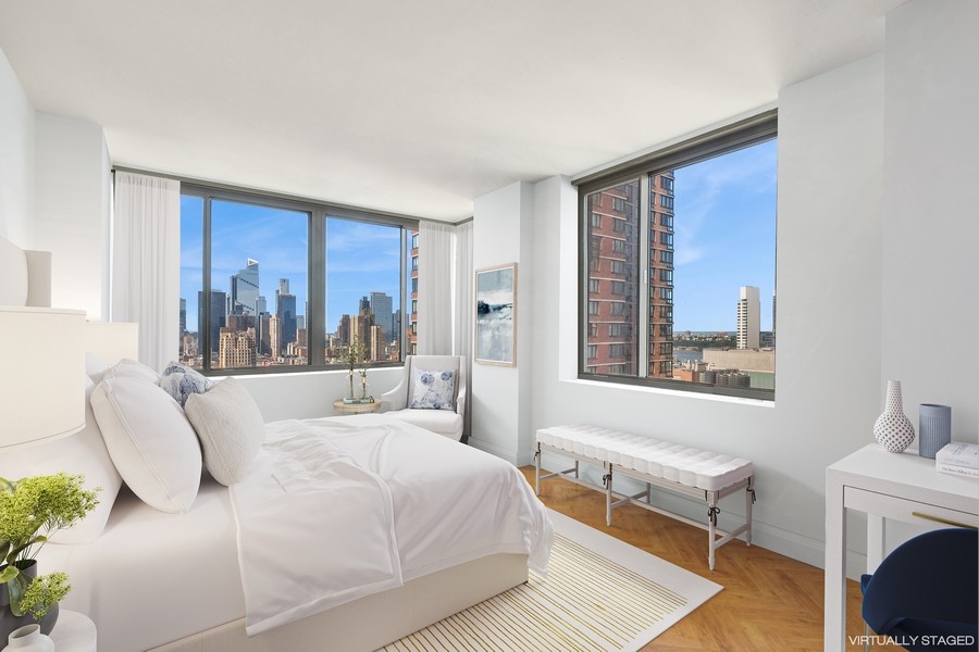 2 Columbus Avenue, Unit 23A Manhattan, NY 10019 - Photo 4 of 10 a bedroom with a bed and a window