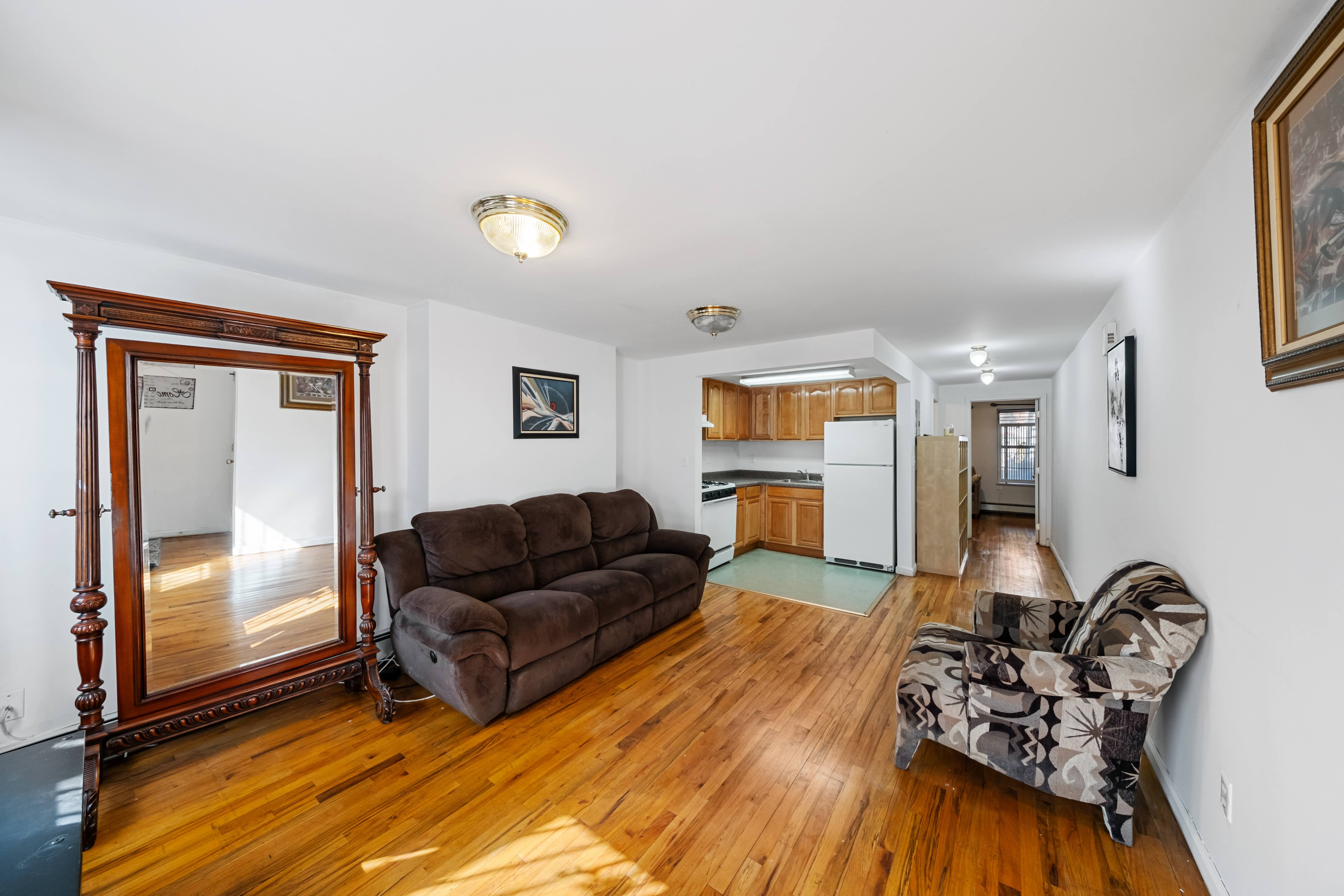 275 Van Buren Street Brooklyn, NY 11221 - Photo 15 of 33 a living room with furniture and wooden floor