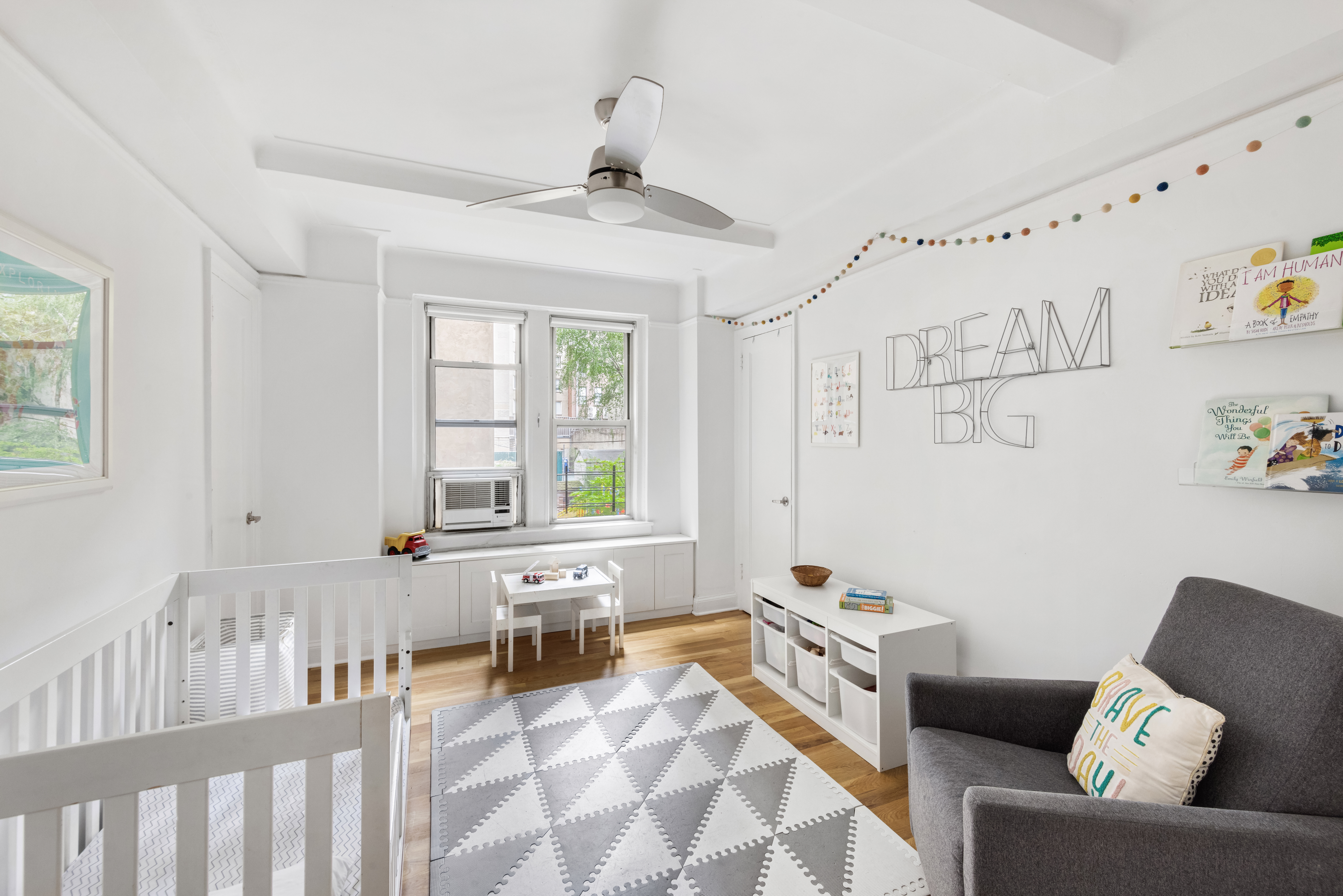 425 East 86th Street, Unit 2F Manhattan, NY 10028 - Photo 7 of 11 a living room with furniture and a large window
