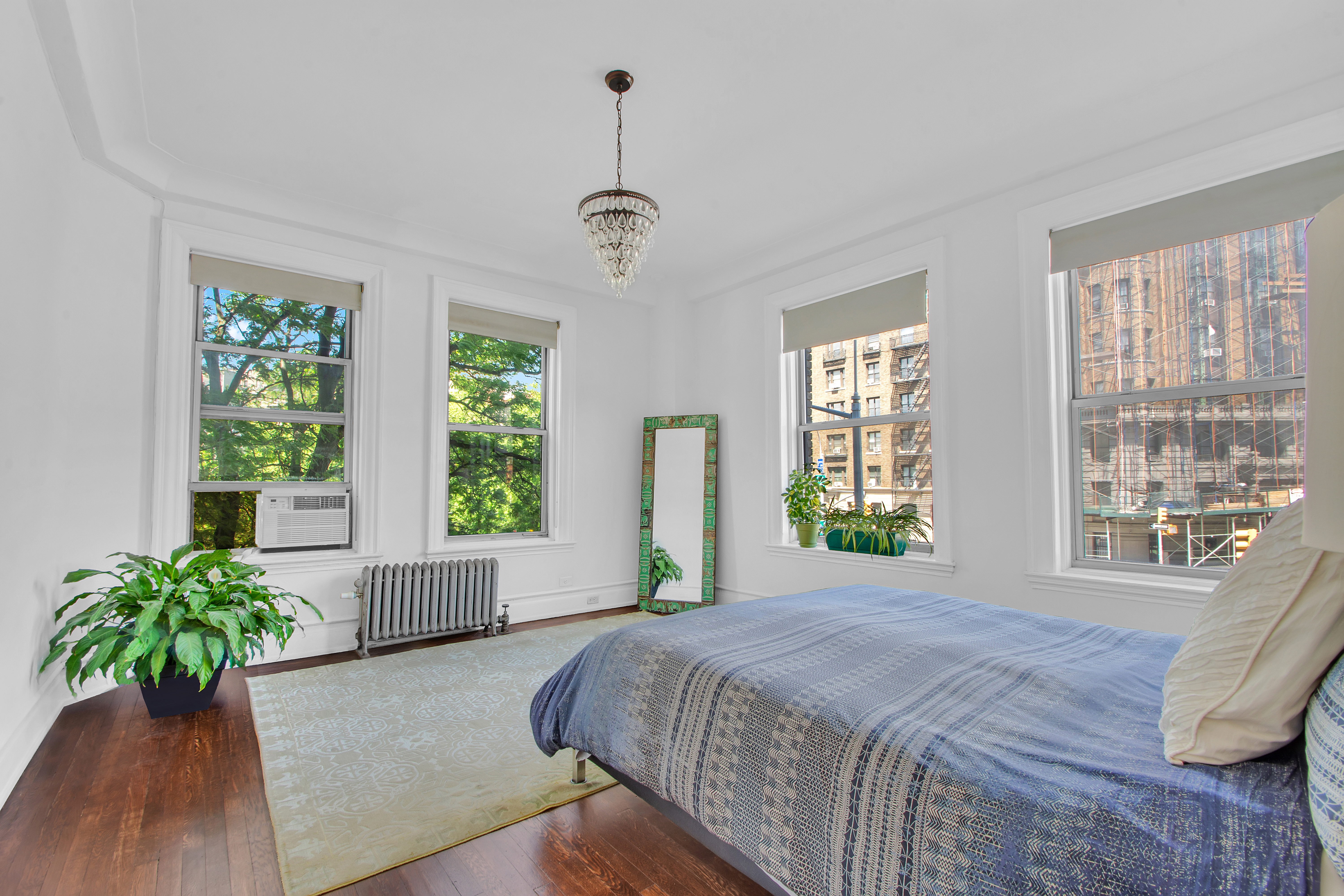 800 Riverside Drive, Unit 2E Manhattan, NY 10032 - Photo 11 of 27 a spacious bedroom with a large bed and a large window