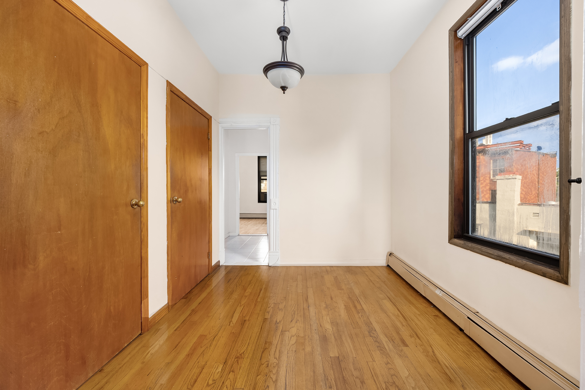 18 Russell Street Brooklyn, NY 11222 - Photo 20 of 24 a view of a hallway with wooden floor and a window