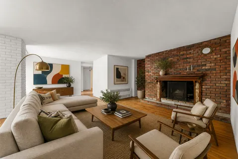 a living room with furniture and a fireplace