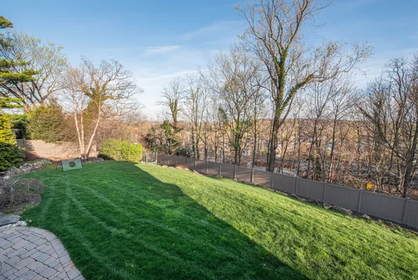 a view of a backyard with large trees