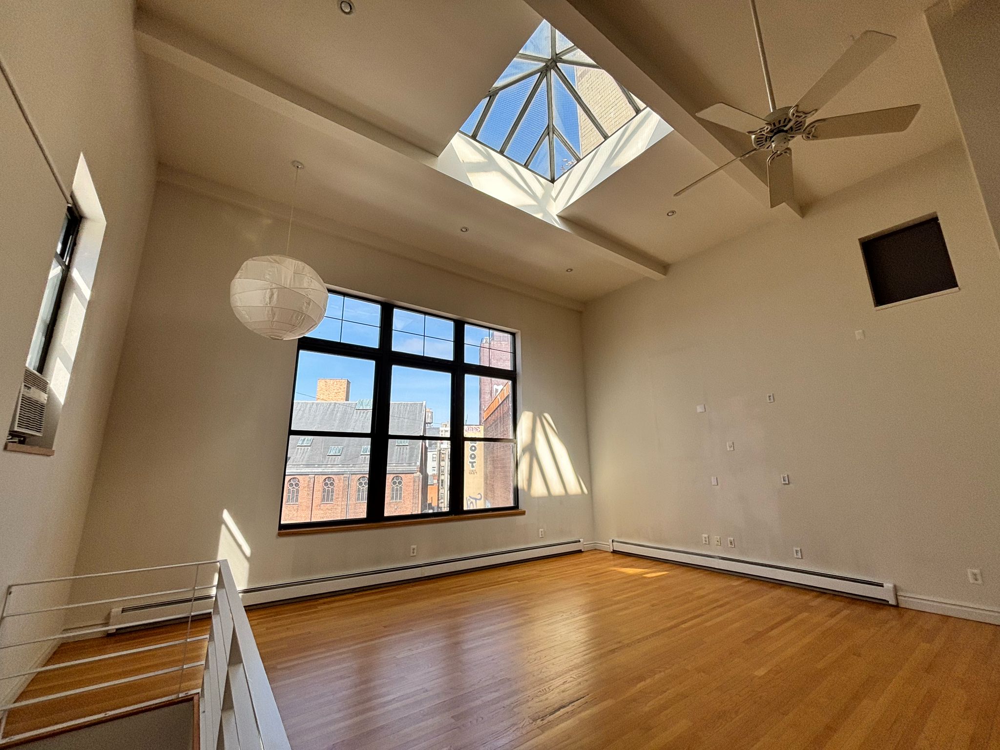 85 Division Street, Unit 4 Manhattan, NY 10002 - Photo 15 of 22 wooden floor in an empty room with a window
