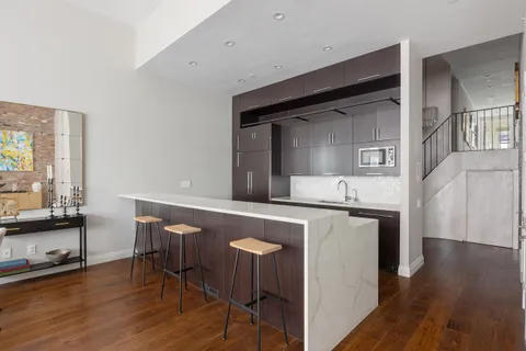a kitchen with sink and refrigerator