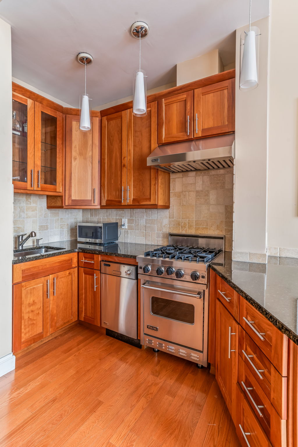 120 East 87th Street, Unit R6L Manhattan, NY 10028 - Photo 7 of 19 a kitchen with stainless steel appliances granite countertop a stove sink and cabinets