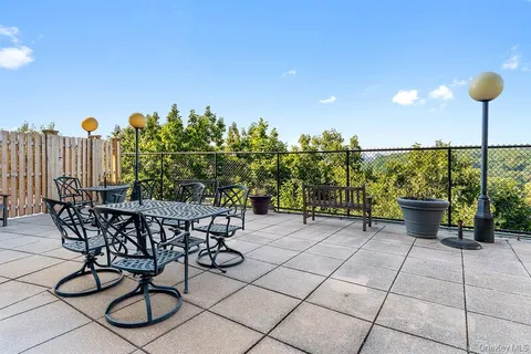 a view of a chairs and table in patio