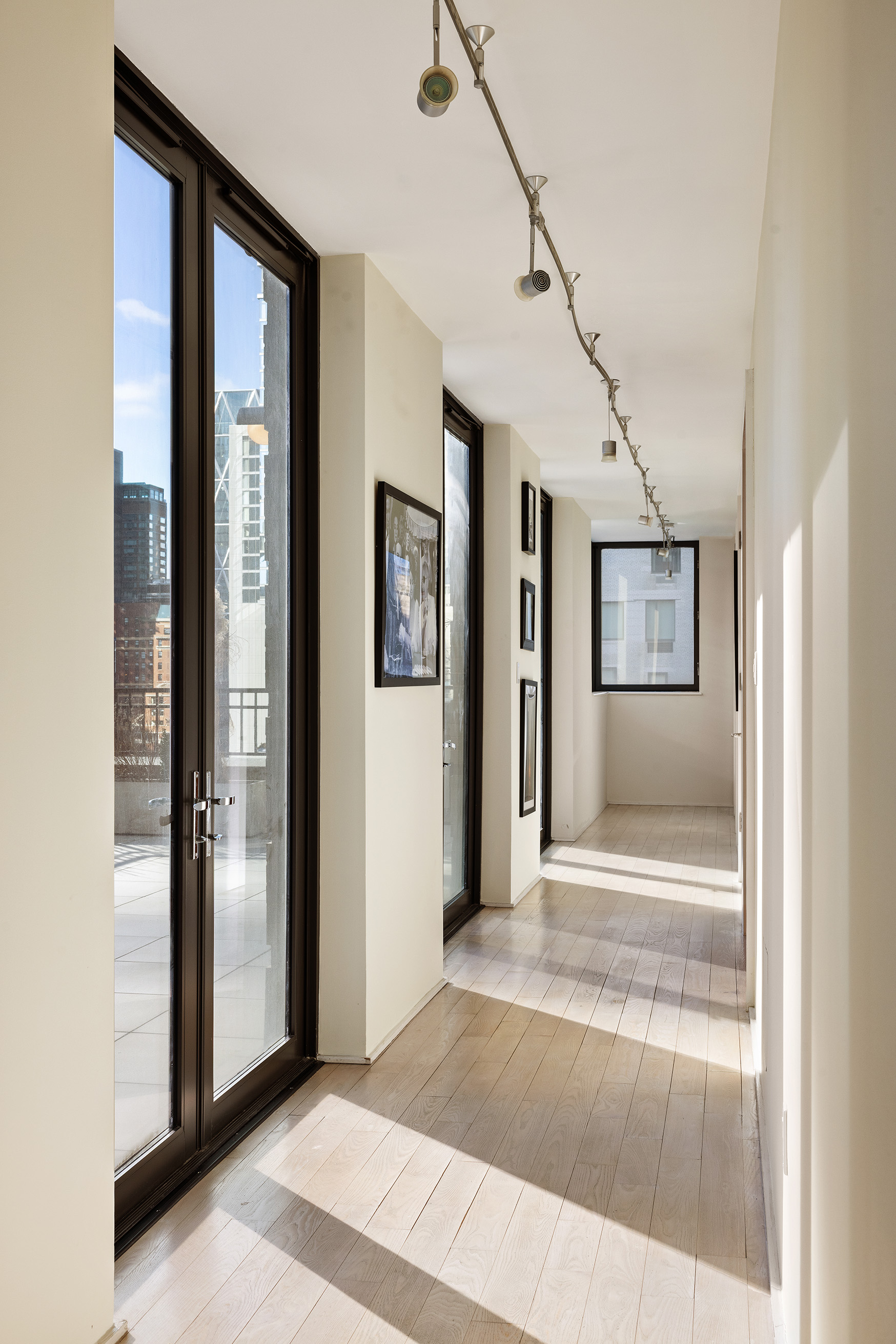 110 Central Park South, Unit PH1 Manhattan, NY 10019 - Photo 14 of 26 a view of a hallway with wooden floor and a living room