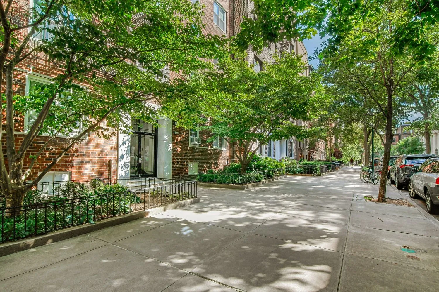 a view of a street with a building and trees in the background