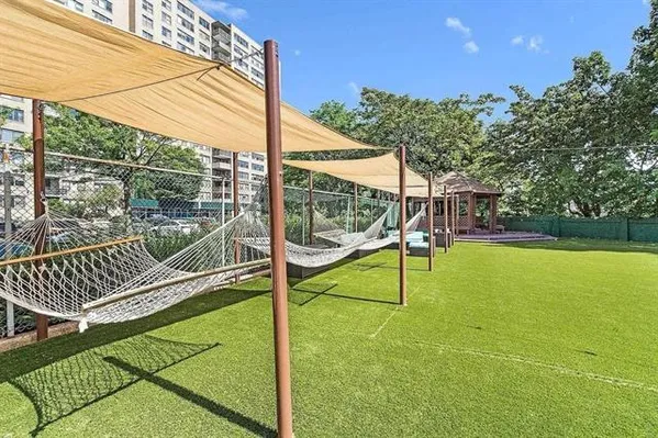 a view of a tennis ground with a small pool
