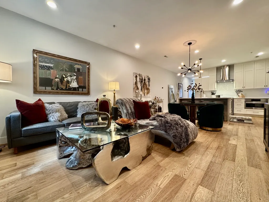 a living room with furniture and a chandelier